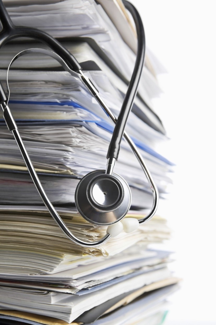 Medical record concept using stethoscope in front of pile of paper. Selective focus